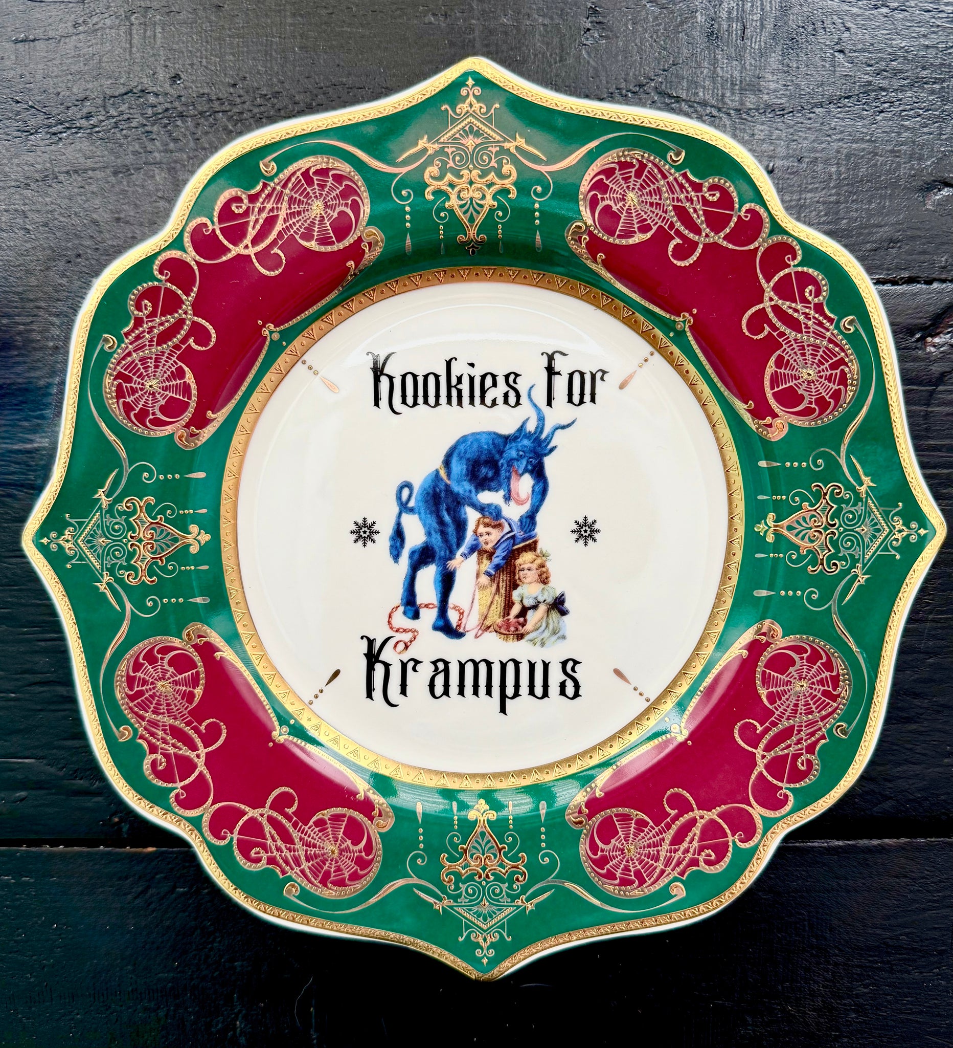 2025 Limited Edition Kookies for Krampus salad plate featuring Krampus overseeing Victorian children, framed in emerald, crimson, and gold.