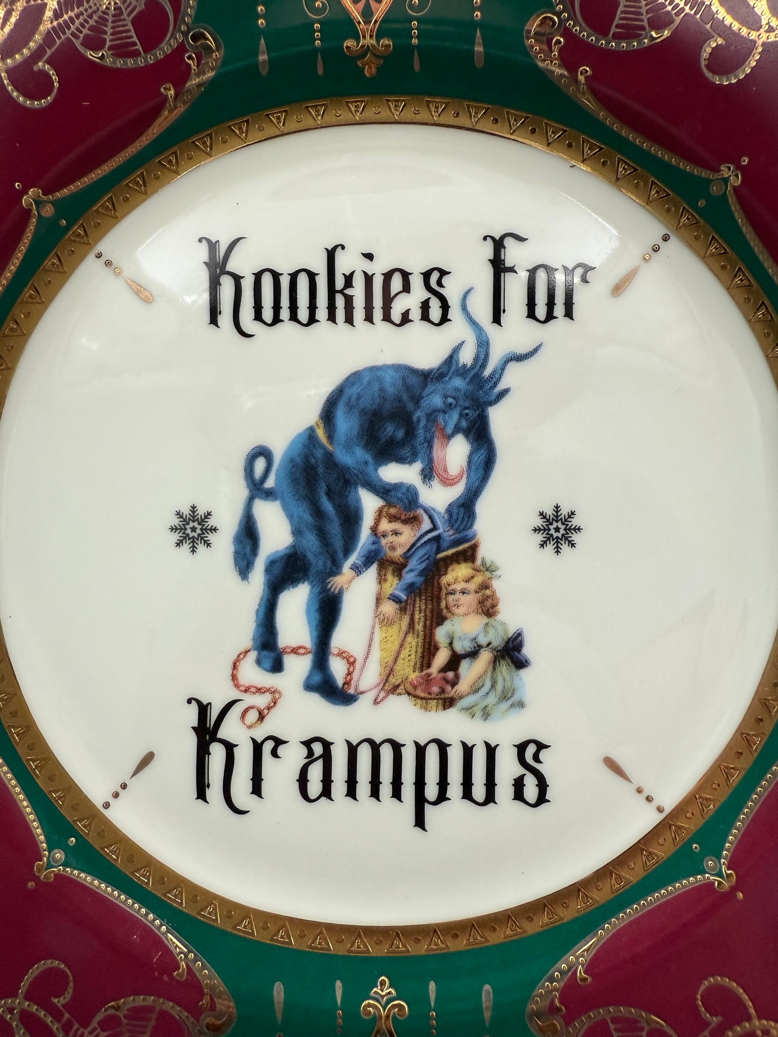 Close-up view of the 2025 Limited Edition Kookies for Krampus salad plate showcasing intricate golden spiderweb details and the mischievous spirit of Krampus.